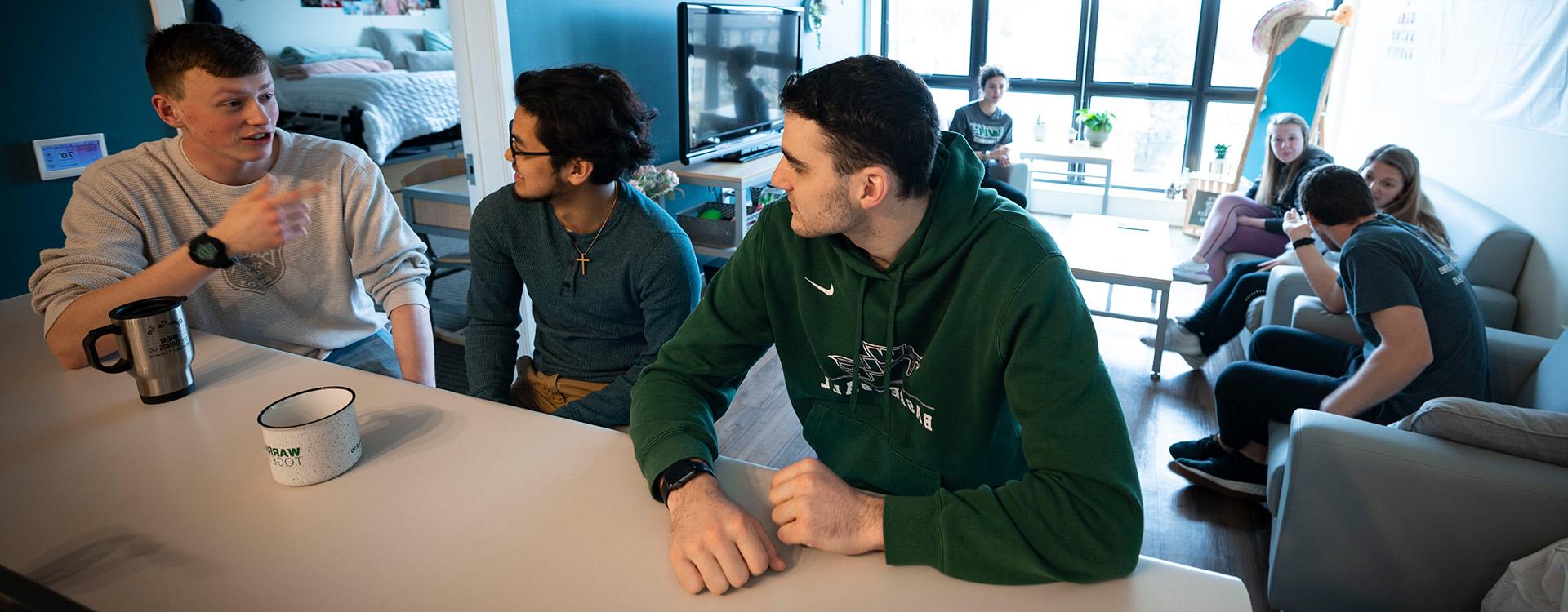 Students talking in apartment